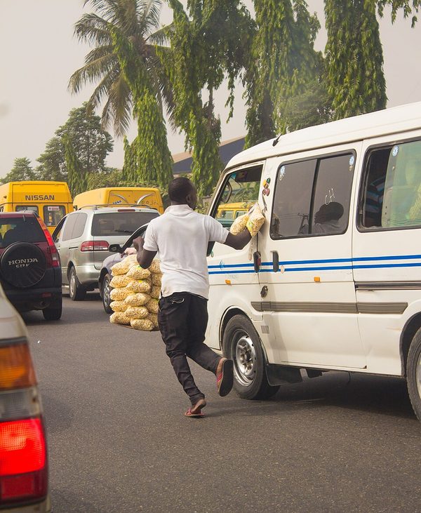 Hawker in Lagos chasing after a bus