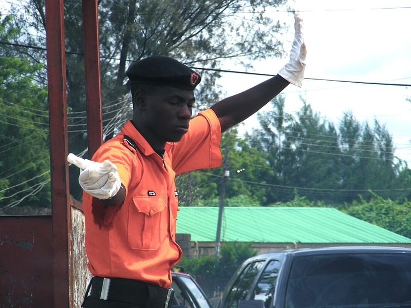 Traffic warden directing cars